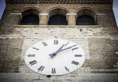 Low angle view of clock on wall