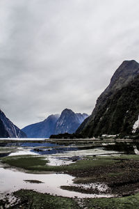 Scenic view of lake and mountains against sky