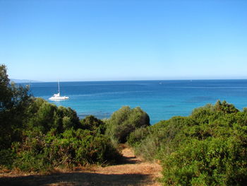 Scenic view of sea against clear blue sky