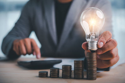 Close-up of hand holding light bulb