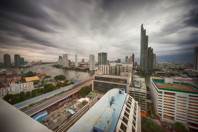 High angle view of cityscape against cloudy sky