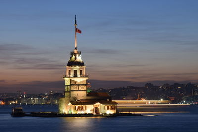 Illuminated building against sky at night