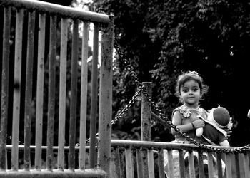 Portrait of smiling little girl behind the railing