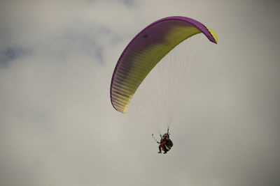 Person paragliding against sky