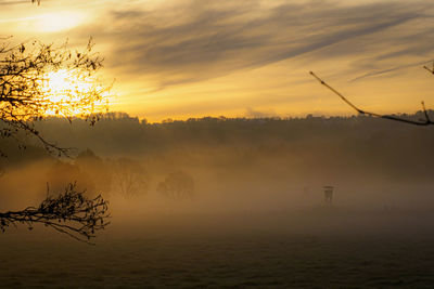 Scenic view of sunset in the morning mist