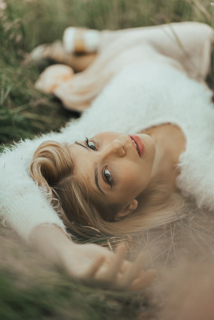 lying down, young adult, one person, young women, portrait, hair, selective focus, women, beauty, lying on back, looking at camera, relaxation, beautiful woman, blond hair, real people, resting, day, three quarter length, hairstyle, contemplation