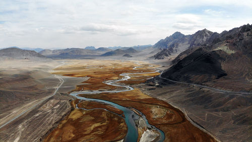 Aerial view of landscape against cloudy sky