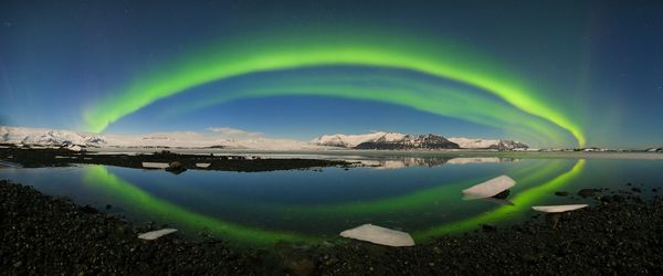 Scenic view of lake against sky at night