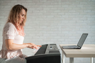 Young woman using laptop at home