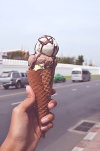 Cropped hand of person holding ice cream cone