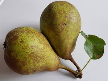 Close-up of fruits on table against white background