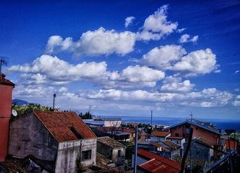 Houses against cloudy sky