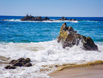 Scenic view of sea against clear blue sky