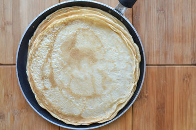 Directly above shot of pancake in cooking utensil on table