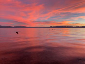 Scenic view of sea against romantic sky at sunset