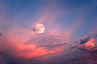 Low angle view of moon at sunset