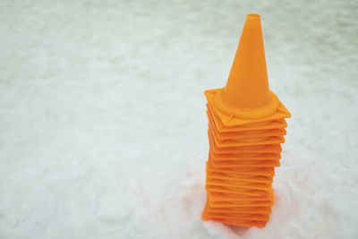 Orange caps in snow. motion limiters. signal triangles. warning signs.