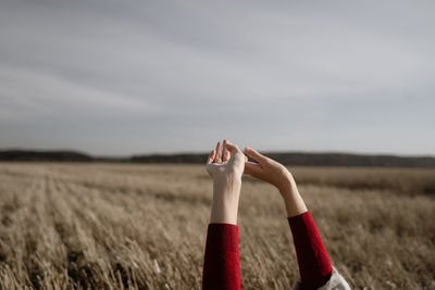 Midsection of child on land against sky