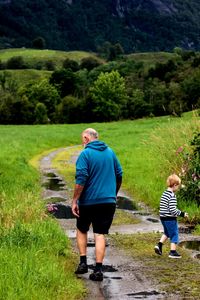 Grandfather and grandson on pathway