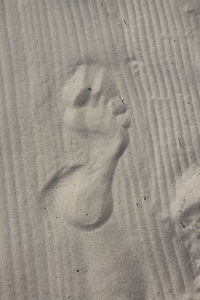 High angle view of footprints on sand