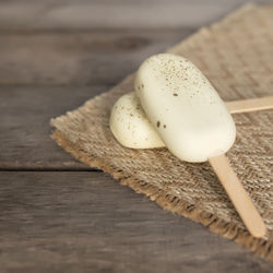 White shiny cookie ice creams on a stick on wooden background. high quality photo