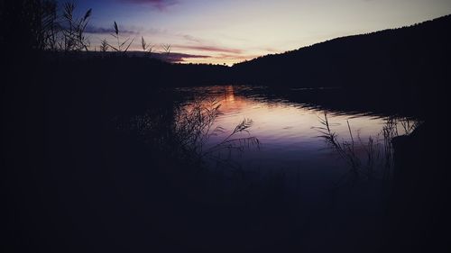 Scenic view of silhouette mountains against sky at sunset