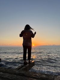 Scenic view of sea against clear sky during sunset