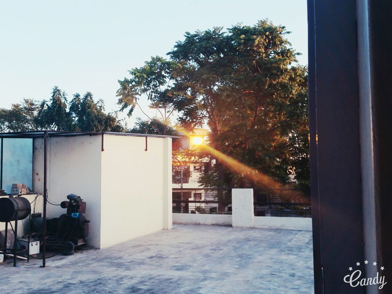 VIEW OF BUILT STRUCTURE WITH TREES IN FOREGROUND