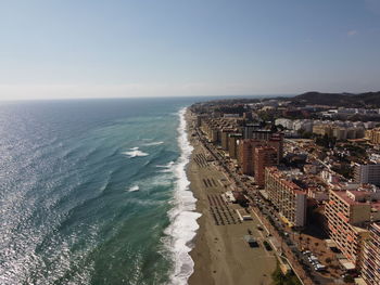 High angle view of sea and buildings against sky