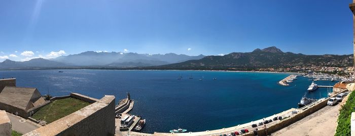 High angle view of bay against blue sky