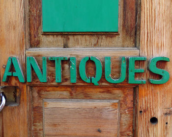 Close-up of text on old wooden door