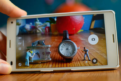 Close-up of person using mobile phone on table