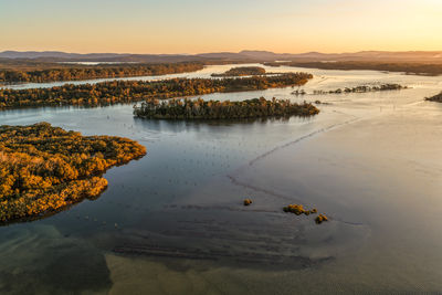 Scenic view of lake against sky during sunset