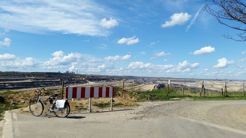 Empty road against cloudy sky