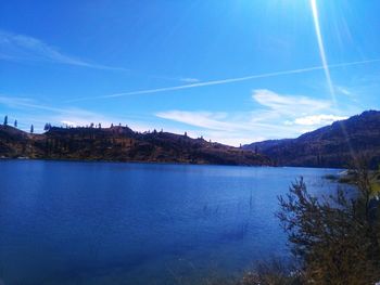 Scenic view of lake against blue sky