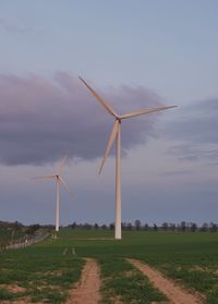 Windmill on field against sky