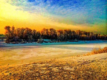 Scenic view of landscape against sky at sunset