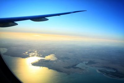 Aerial view of sea against sky during sunset