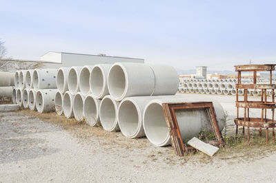 Stack of pipes against sky