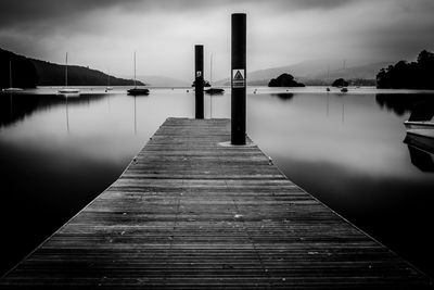 Pier over lake against sky