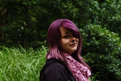 Beautiful young woman standing on grass