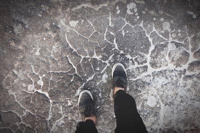 Low section of person standing on footpath