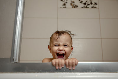 Baby boy shouting in bathtub