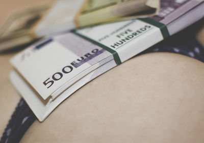 Close-up of paper currencies on woman