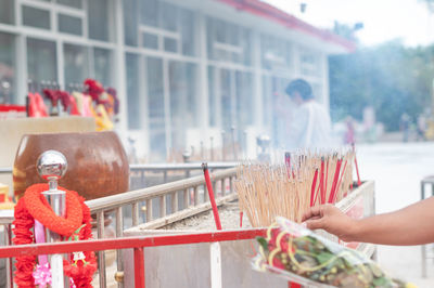 Males put incense in the pot to pay for buddhist in the temple of thailand.