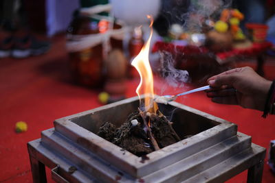 Person holding lit candles in temple