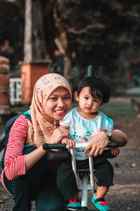 Portrait of smiling woman with daughter