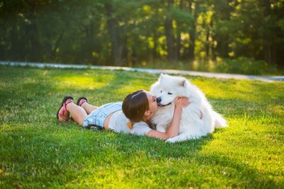 Young woman with dog on field