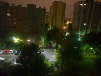 Street amidst buildings in city at night