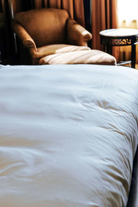 Rear view of man relaxing on bed at home